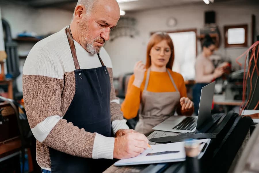 A small-business owner reviewing documents with a banker.