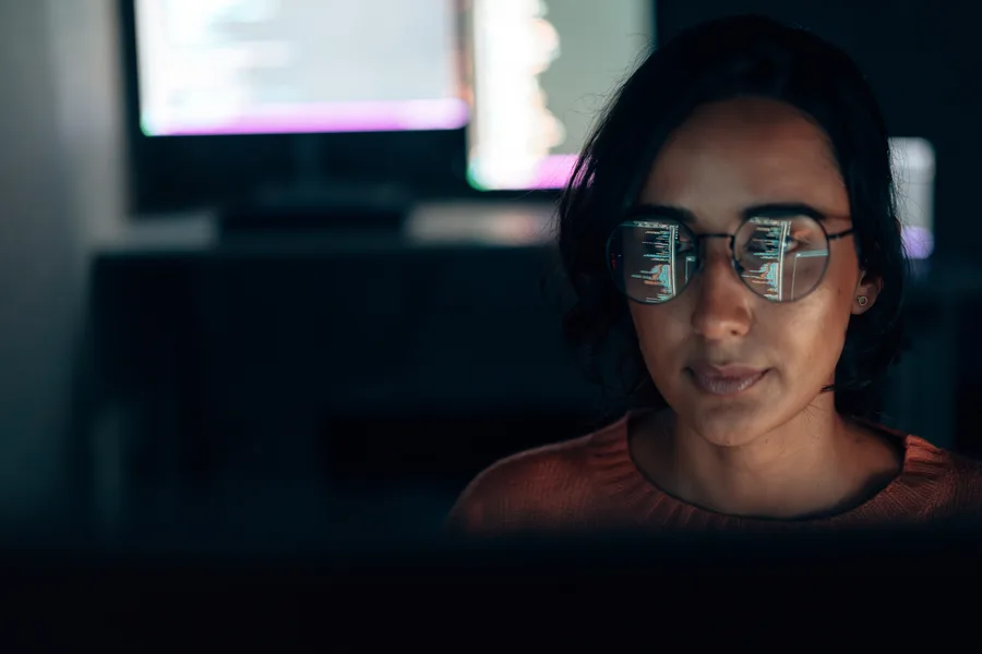 A product team member working late at a screen.